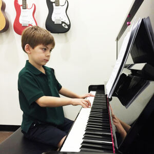 Child in piano lesson.